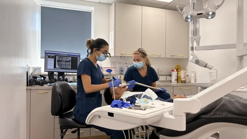 The treatment room mid-appointment, Dr Deesha and a nurse at work